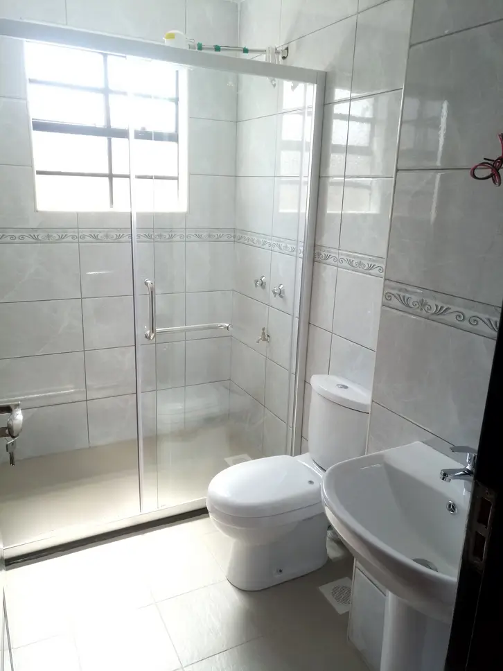 Modern bathroom with glass shower enclosure and white fixtures