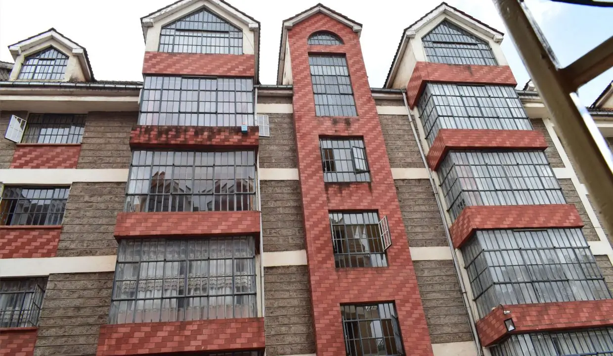 Multi-story residential building with red brick and stone facade