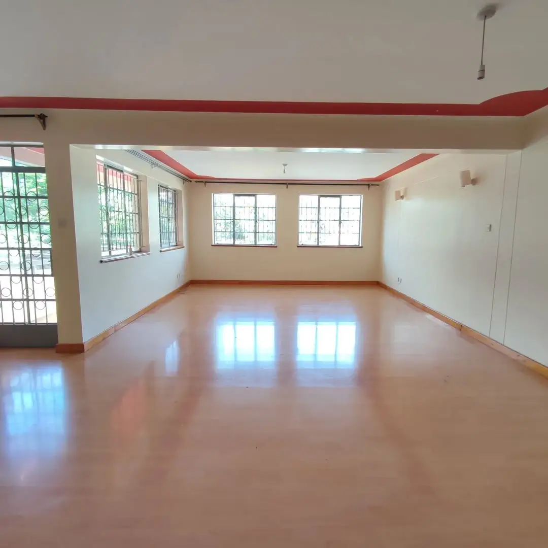 Spacious open-plan living room with polished concrete flooring