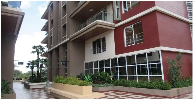 Modern residential building facade with red and brown tones