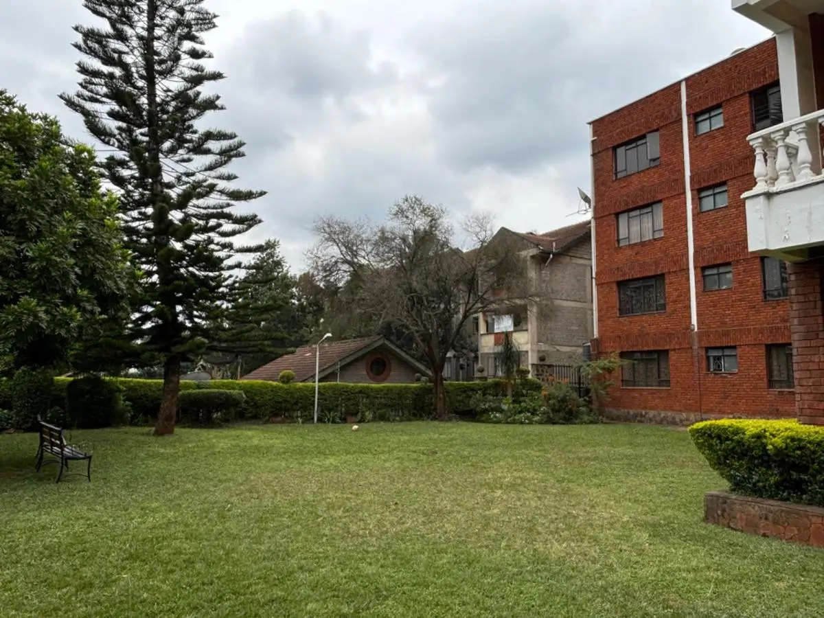 Manicured compound lawn with brick residential building