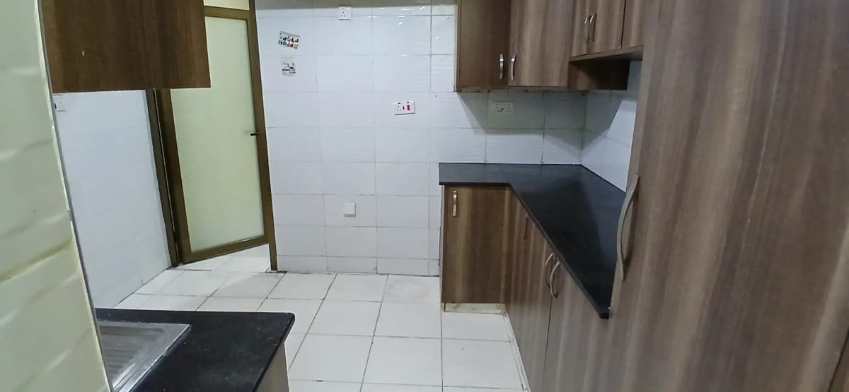 Compact kitchen with black countertop and white tiles