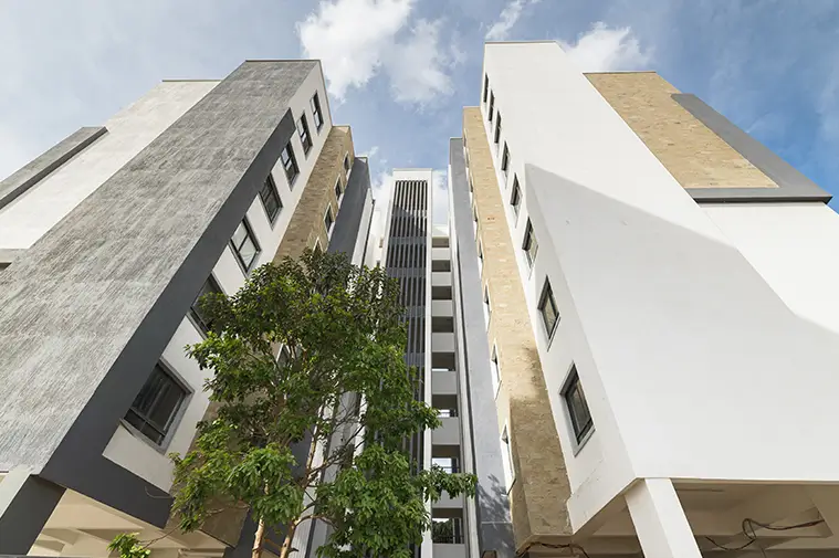Modern residential building facade with courtyard greenery