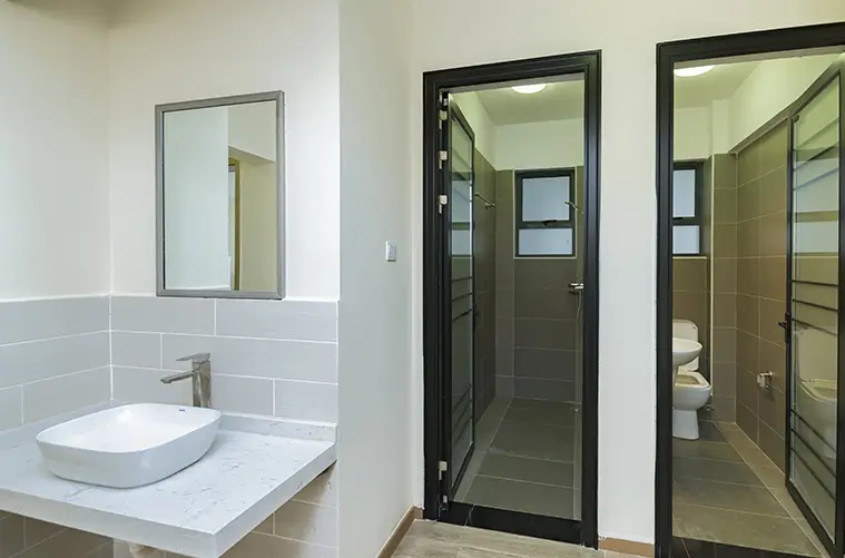 Modern bathroom with vessel sink, mirror, and shower enclosure