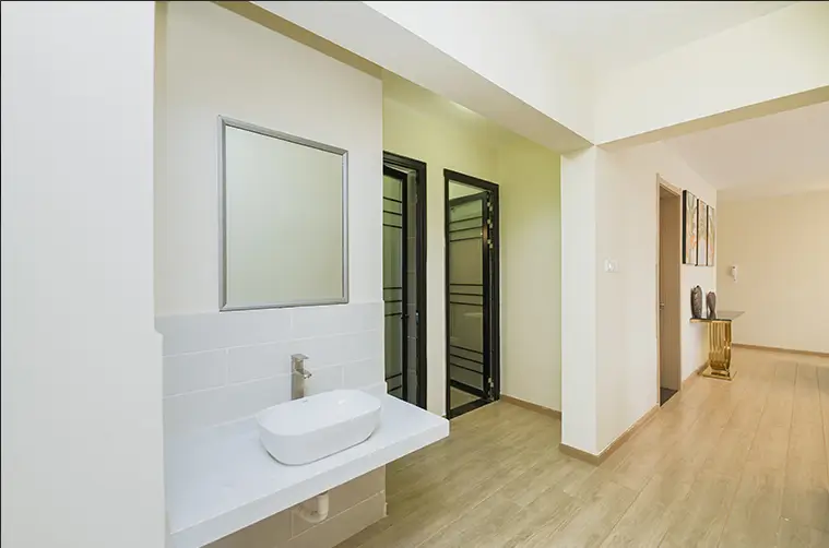 Modern bathroom with vessel sink and mirror, adjacent corridor space