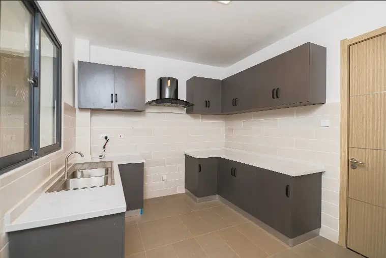 Modern kitchen with dark and white cabinetry, stainless steel hood