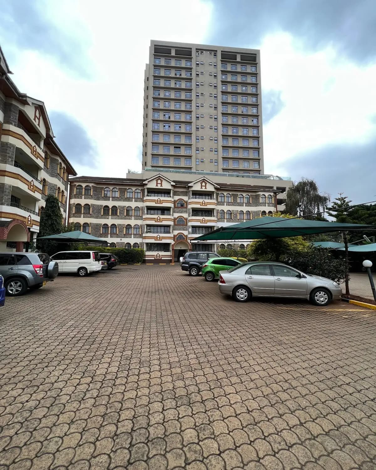 Multi-level apartment building with paved parking compound