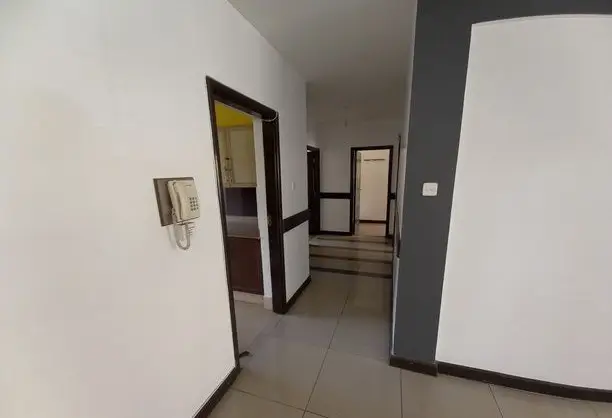 Building corridor with tiled flooring and multiple doors