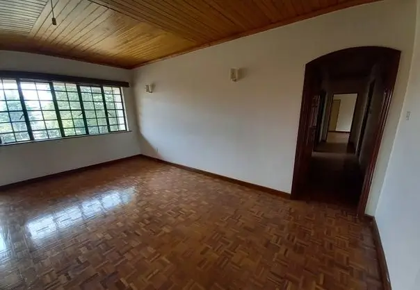 Spacious bedroom with wooden ceiling and parquet flooring