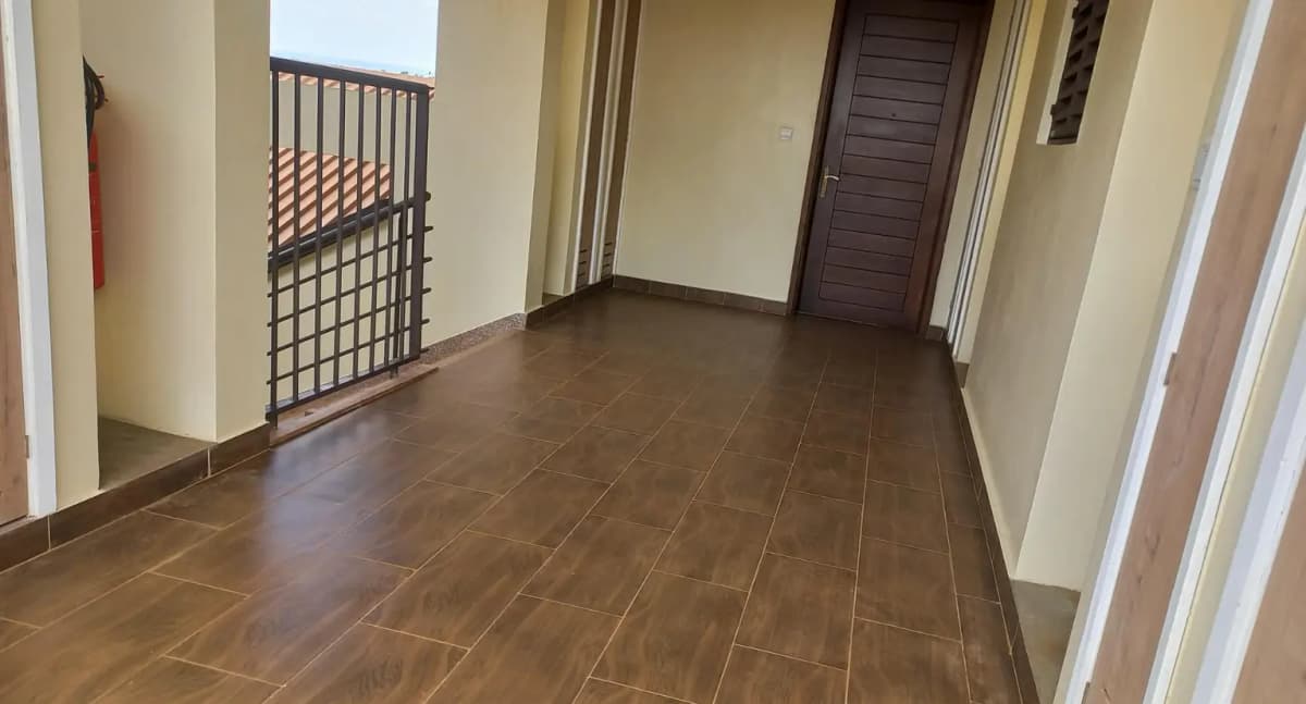 Spacious hallway with herringbone wood flooring and railings