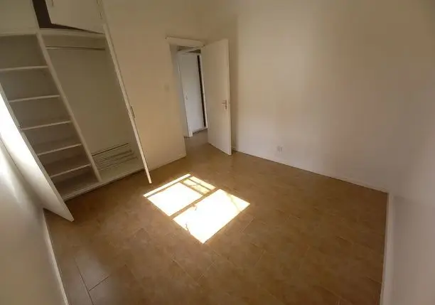 Spacious bedroom with built-in wardrobes and natural light