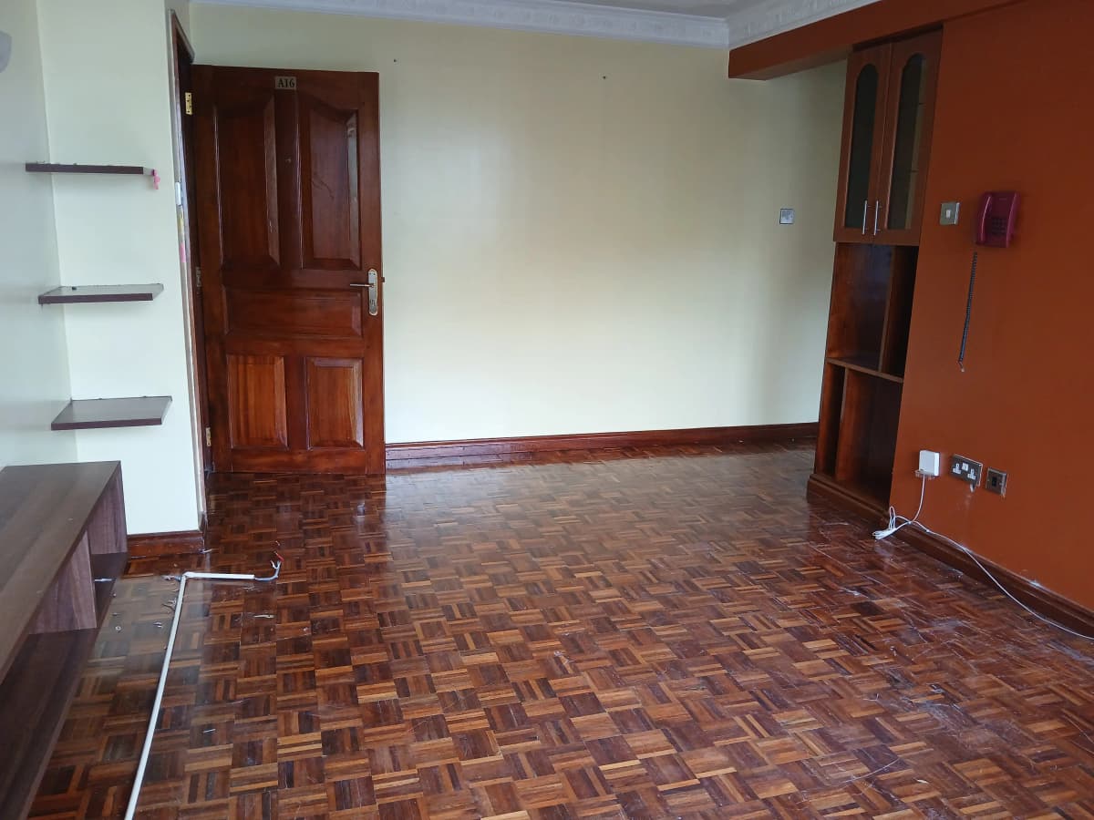 Spacious living room with parquet flooring and wooden doors