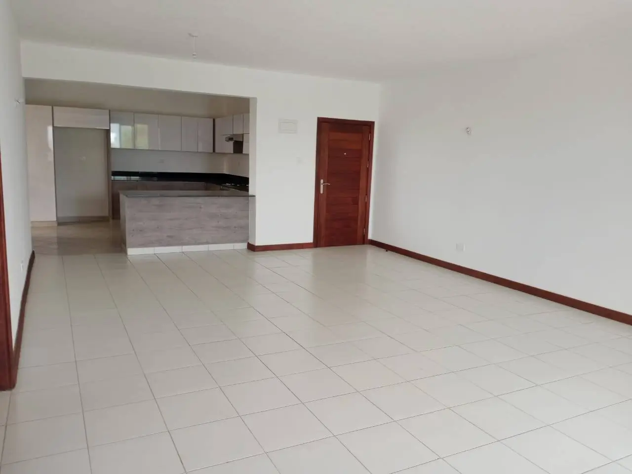 Open-plan living and kitchen area with tiled floors