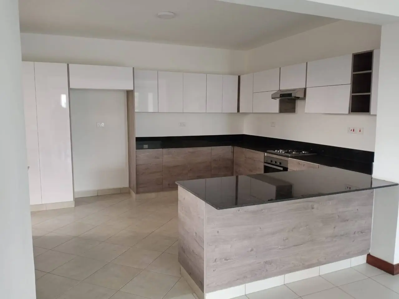 Modern open-plan kitchen with island and black countertops