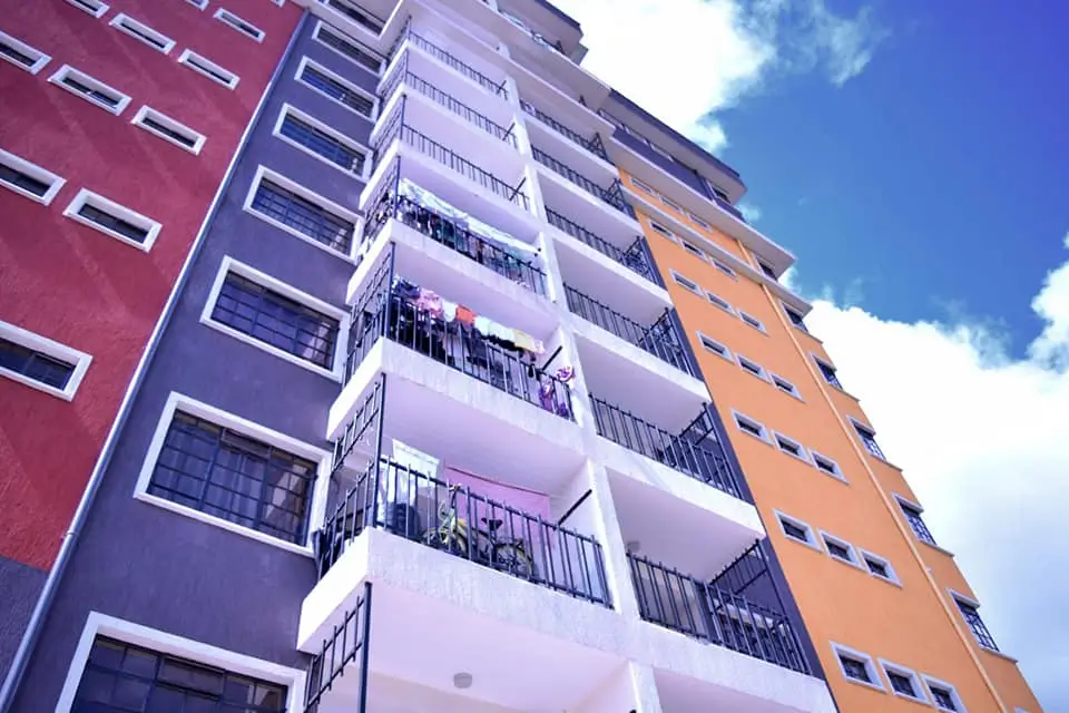 Modern multi-story residential building with colorful facades and balconies