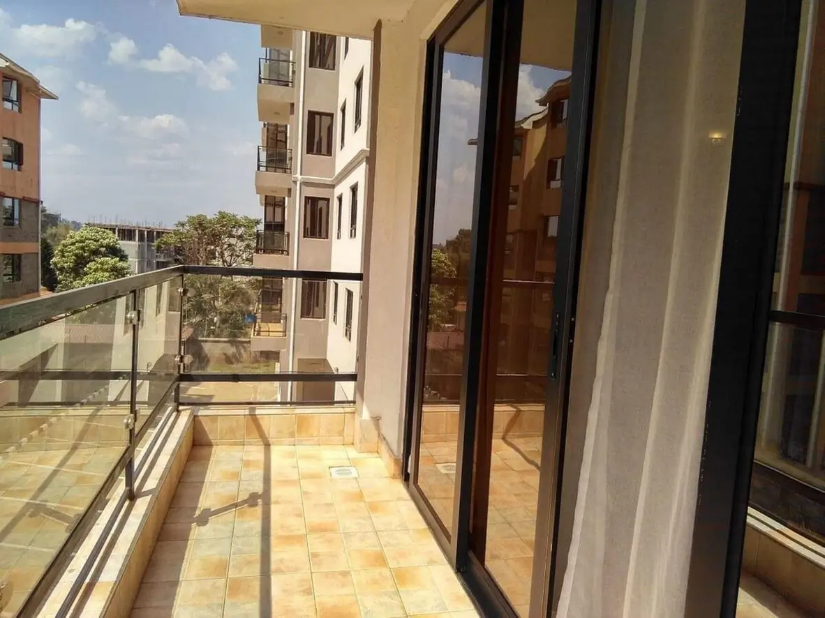 Spacious balcony with terracotta tiles and neighboring apartment views