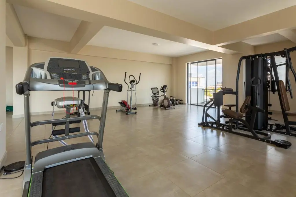 Spacious gym with treadmill, elliptical, and weight machines