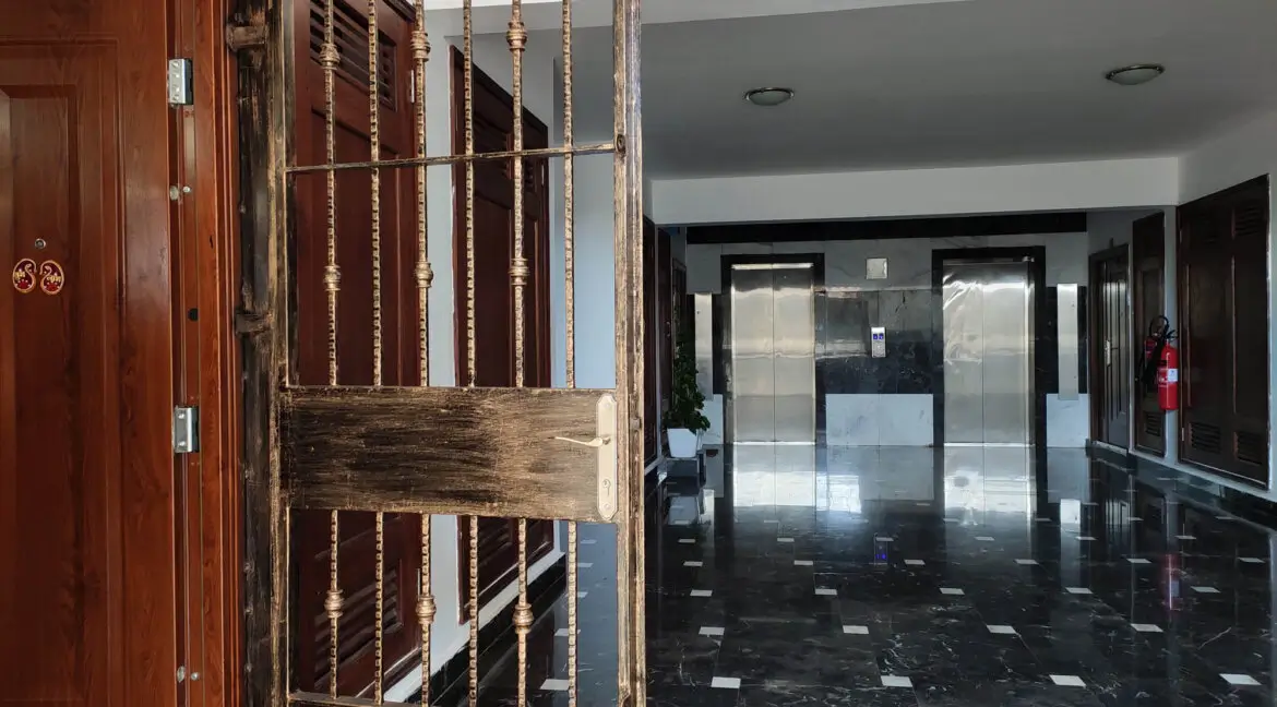 Modern lobby with glass doors and dark polished flooring