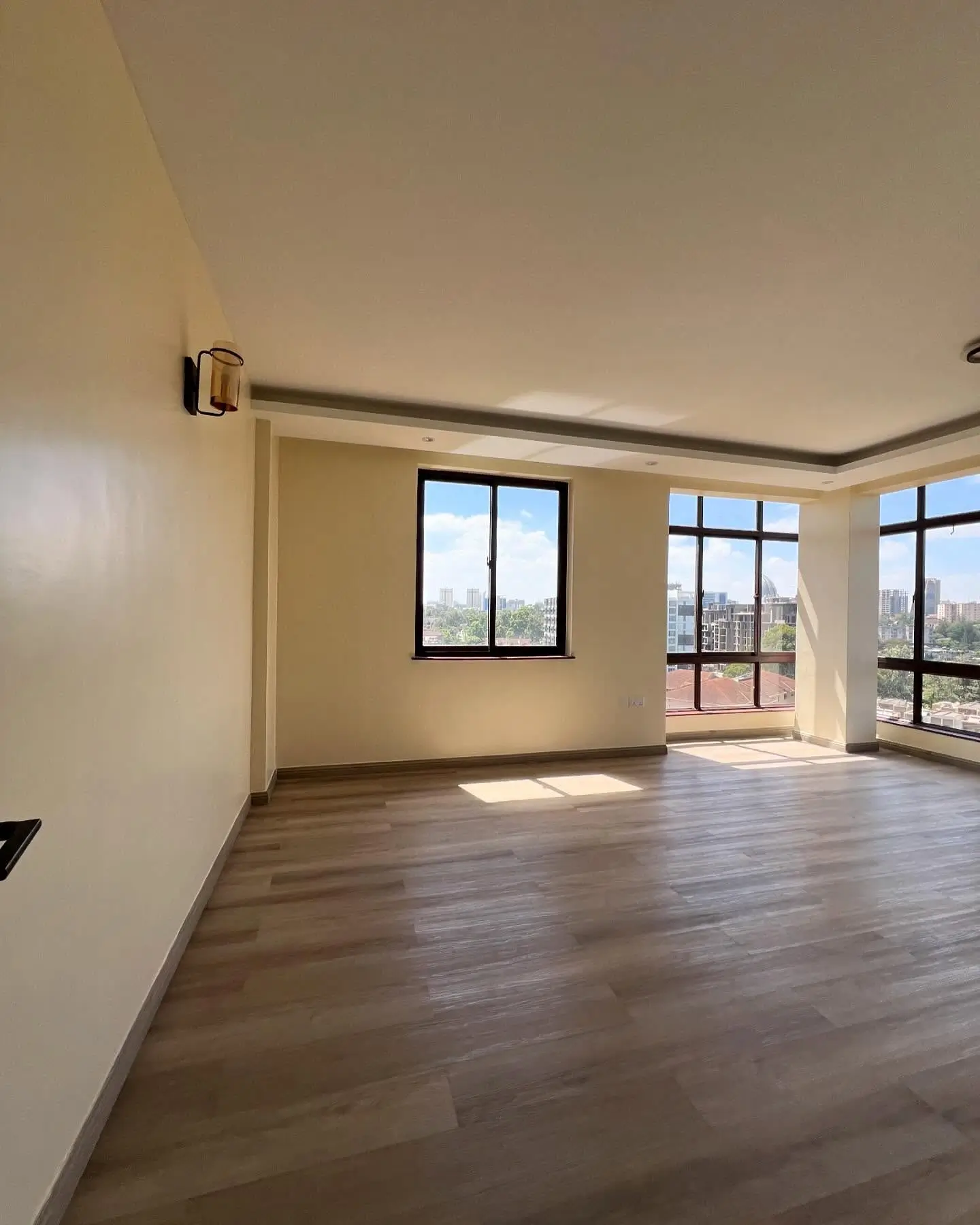Spacious living room with panoramic windows and city views