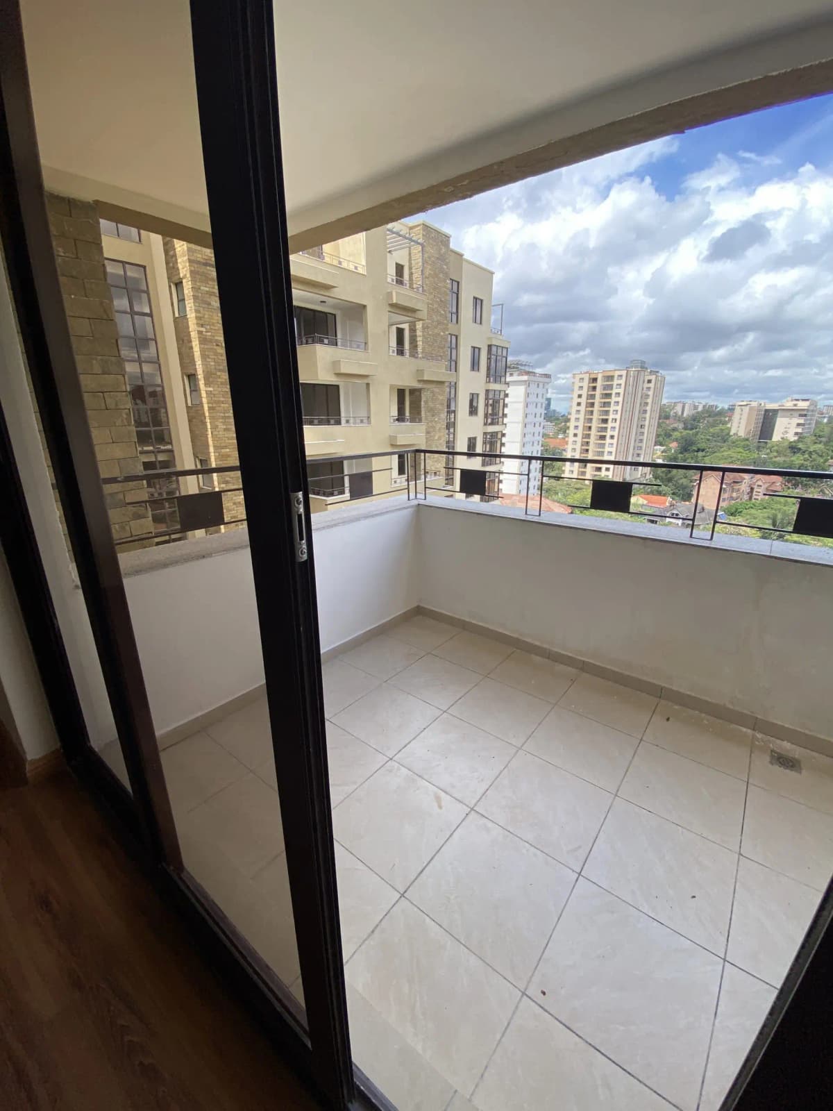 Spacious balcony with city skyline and residential buildings view