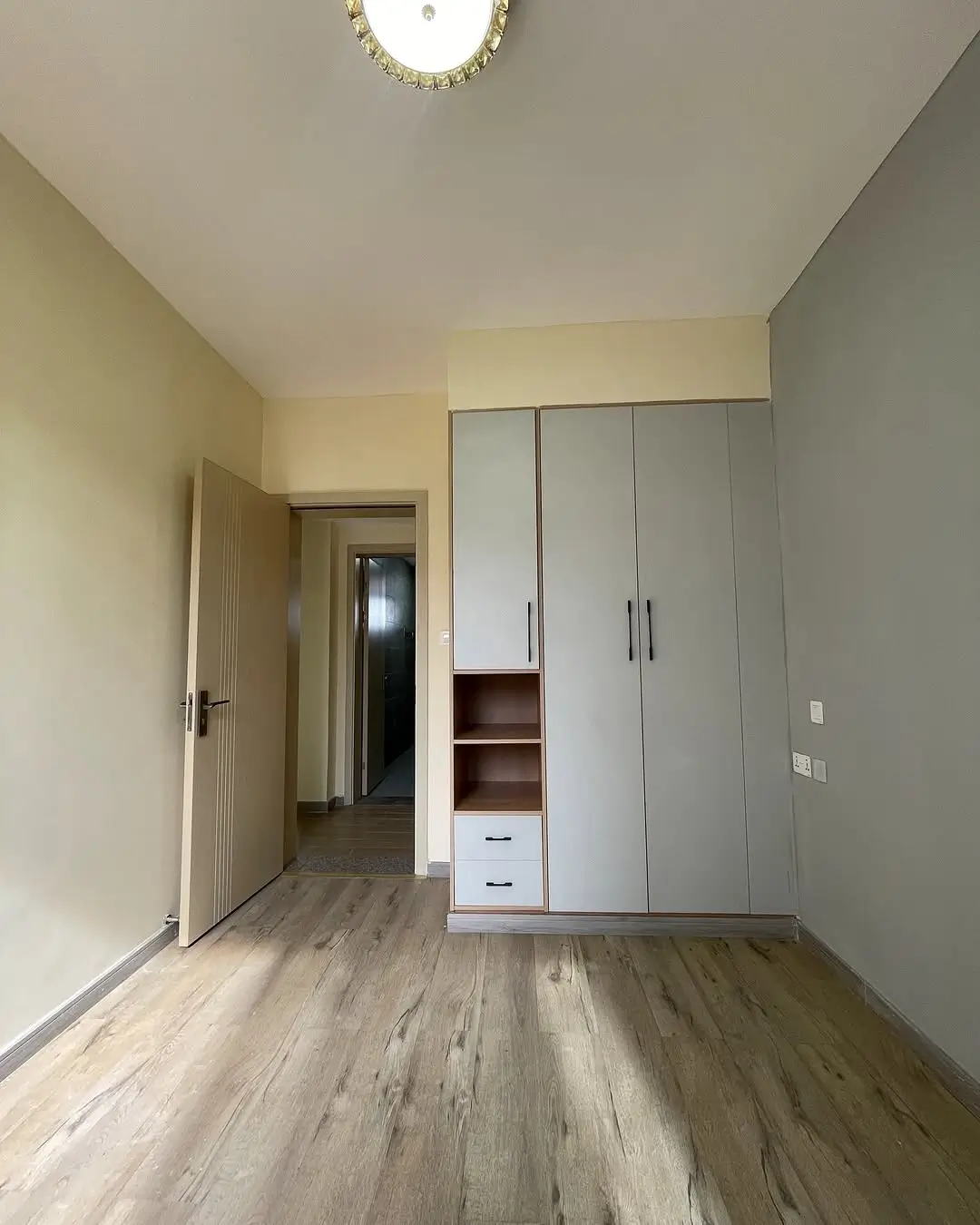 Spacious bedroom with built-in wardrobe and wooden flooring