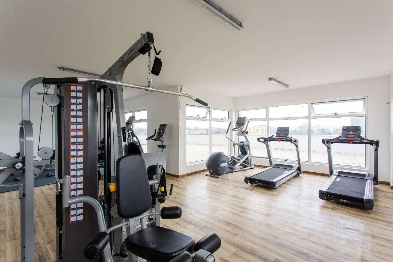 Modern gym with multi-station equipment and treadmills