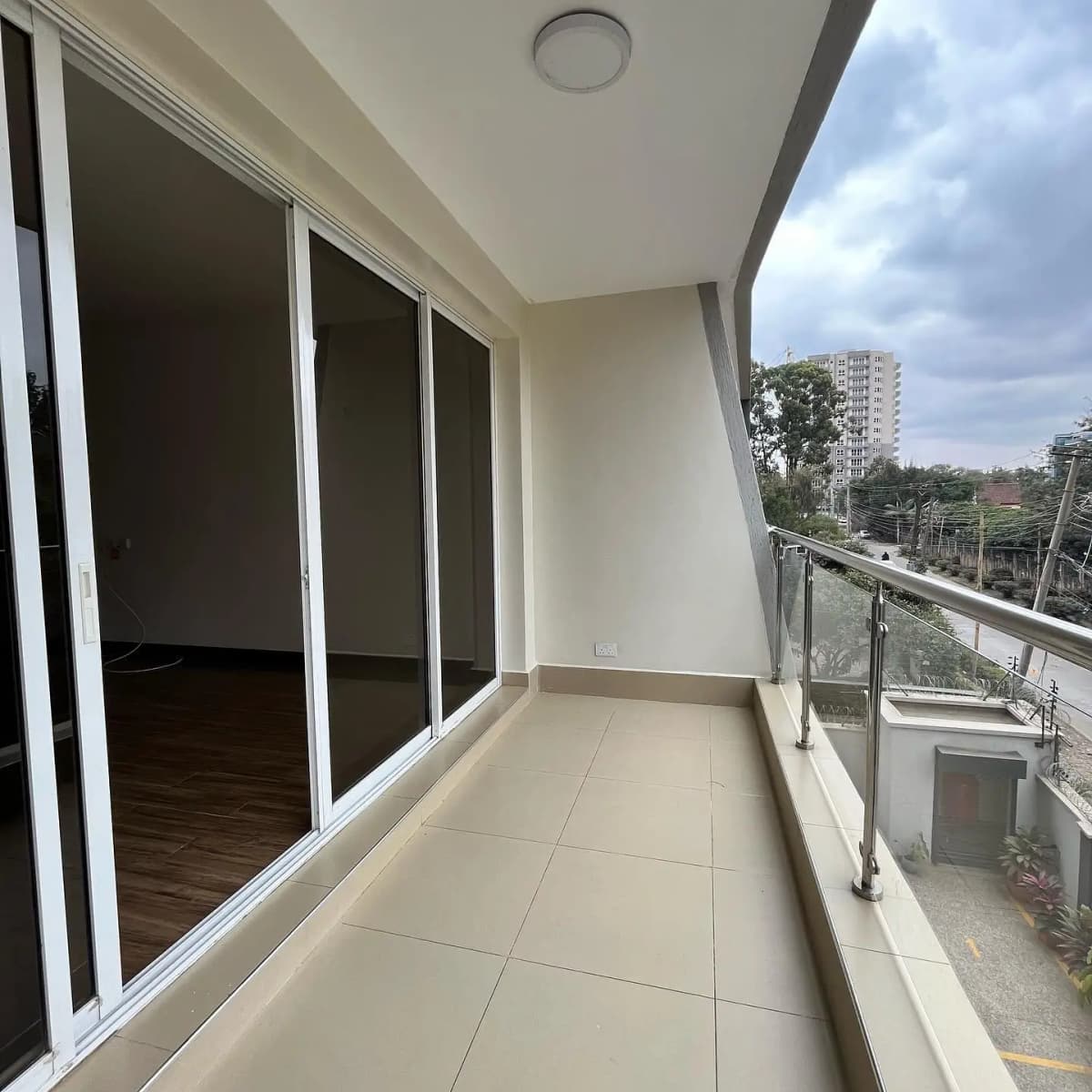 Modern balcony with sliding glass doors overlooking city landscape