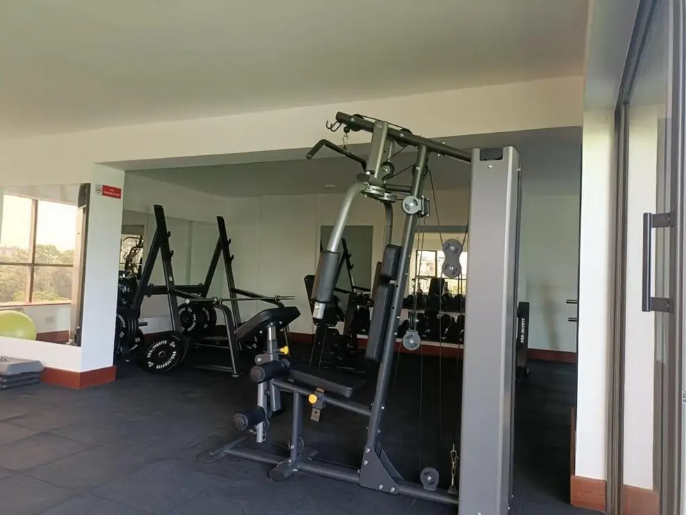 Dedicated fitness room with cardio and strength training equipment