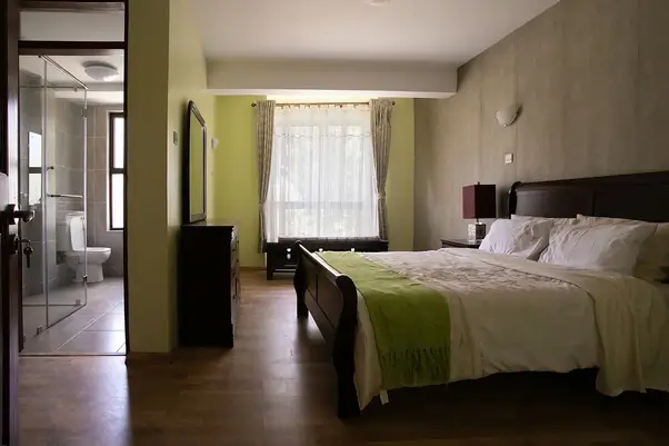 Master bedroom with ensuite bathroom, green accents, city view