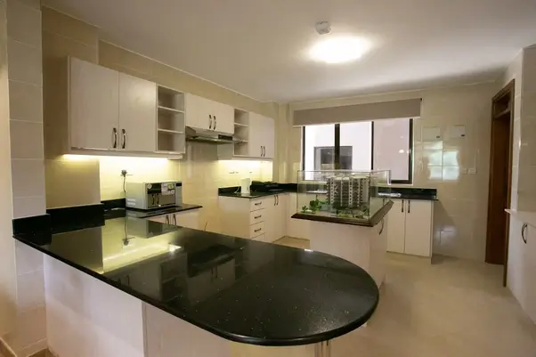 Modern kitchen with black countertops and white cabinetry