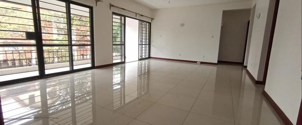 Spacious bright living room with polished floor and large windows
