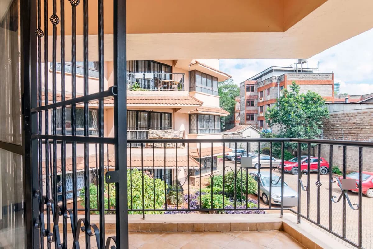 Balcony with metal railing overlooking residential compound