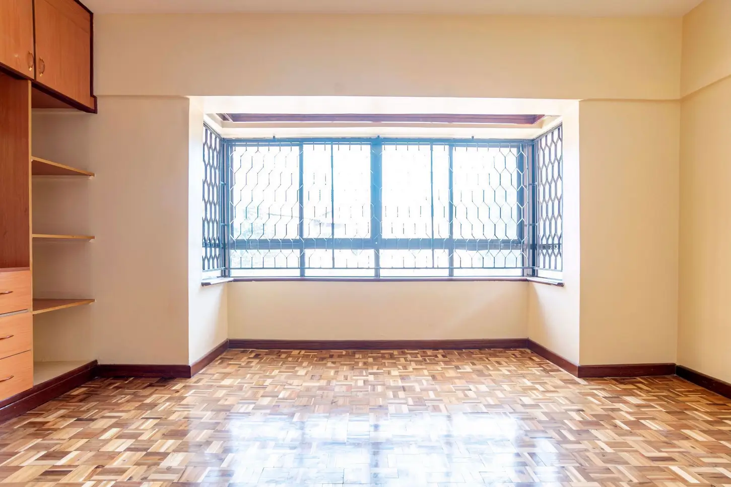 Spacious bedroom with integrated balcony and wooden flooring