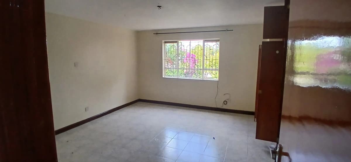 Spacious living room with large window and polished floor