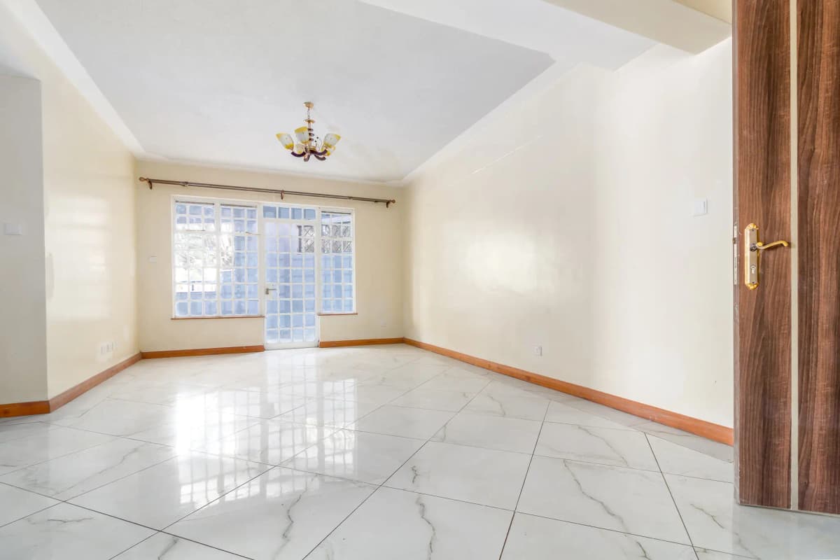 Spacious empty living room with marble flooring and natural light