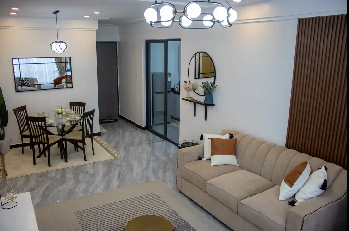 Open-plan living room with beige sofa and dining area