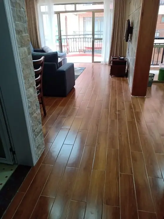Open-plan living room with wood flooring and balcony access