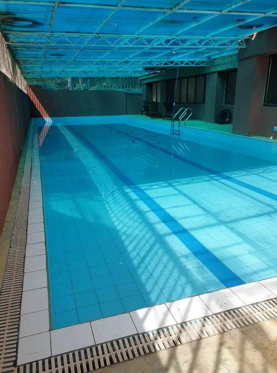 Indoor Olympic-length swimming pool with blue lane markings