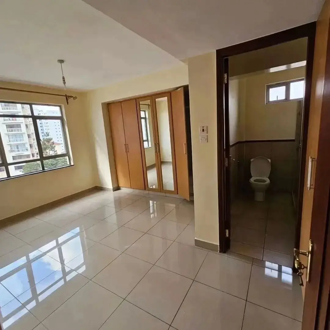 Spacious living area with polished tile flooring and bright windows