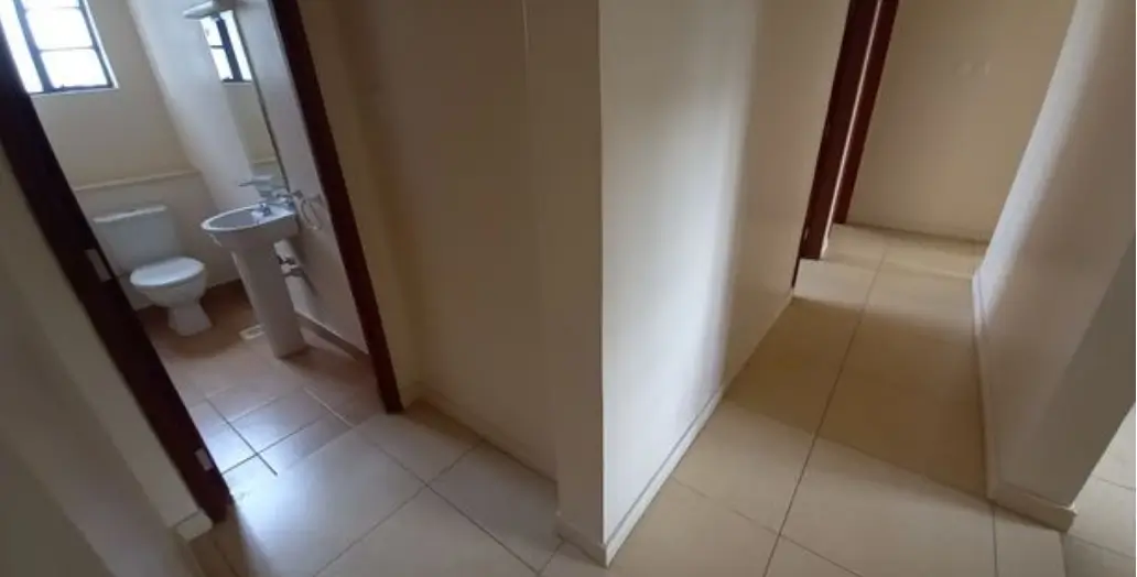 Bright hallway with tiled floors and wooden doors