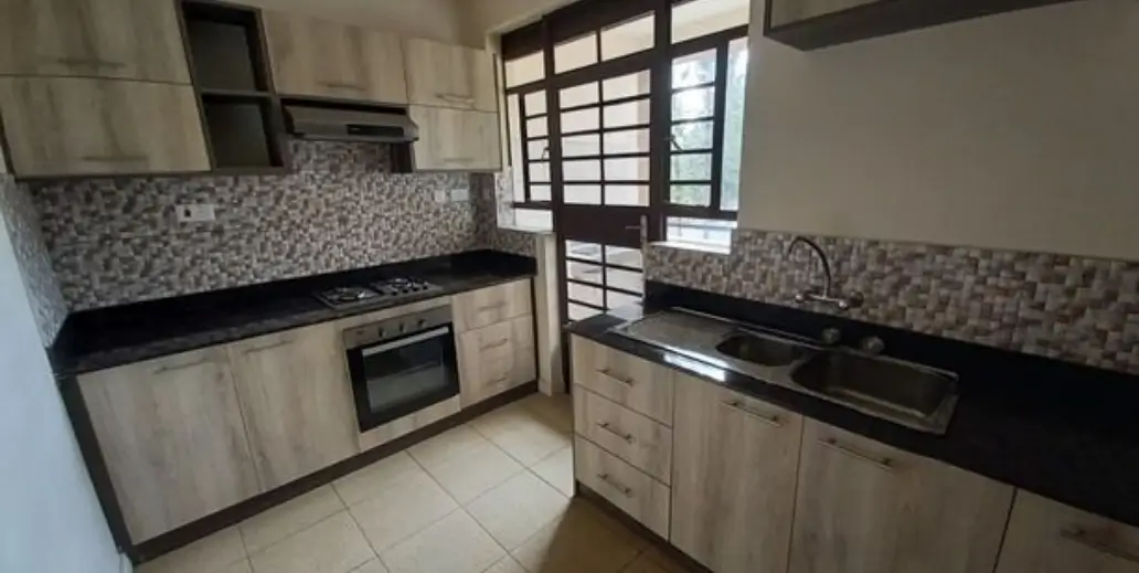 Modern kitchen with black countertops and patterned backsplash