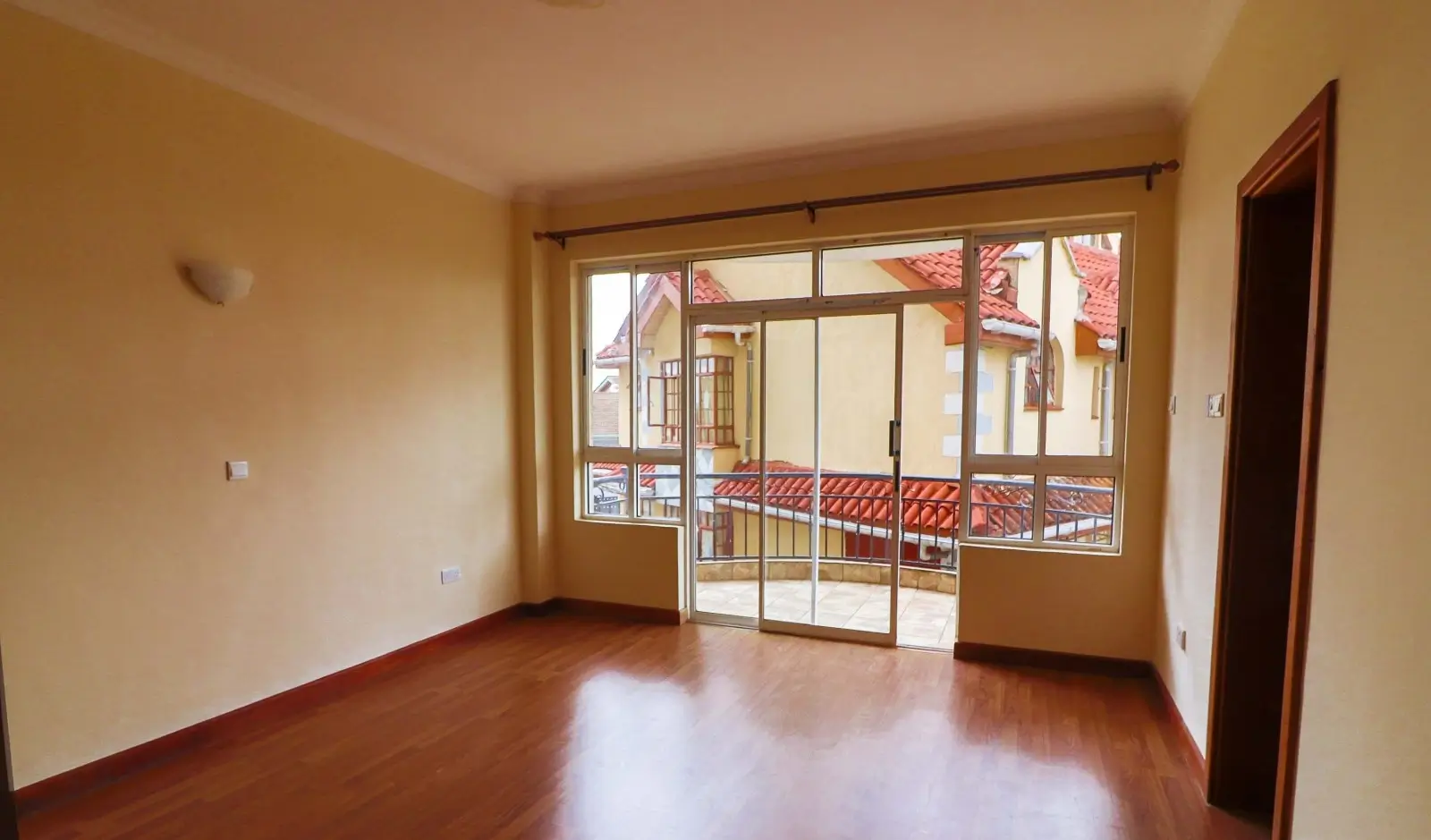 Spacious living room with direct balcony access and natural light