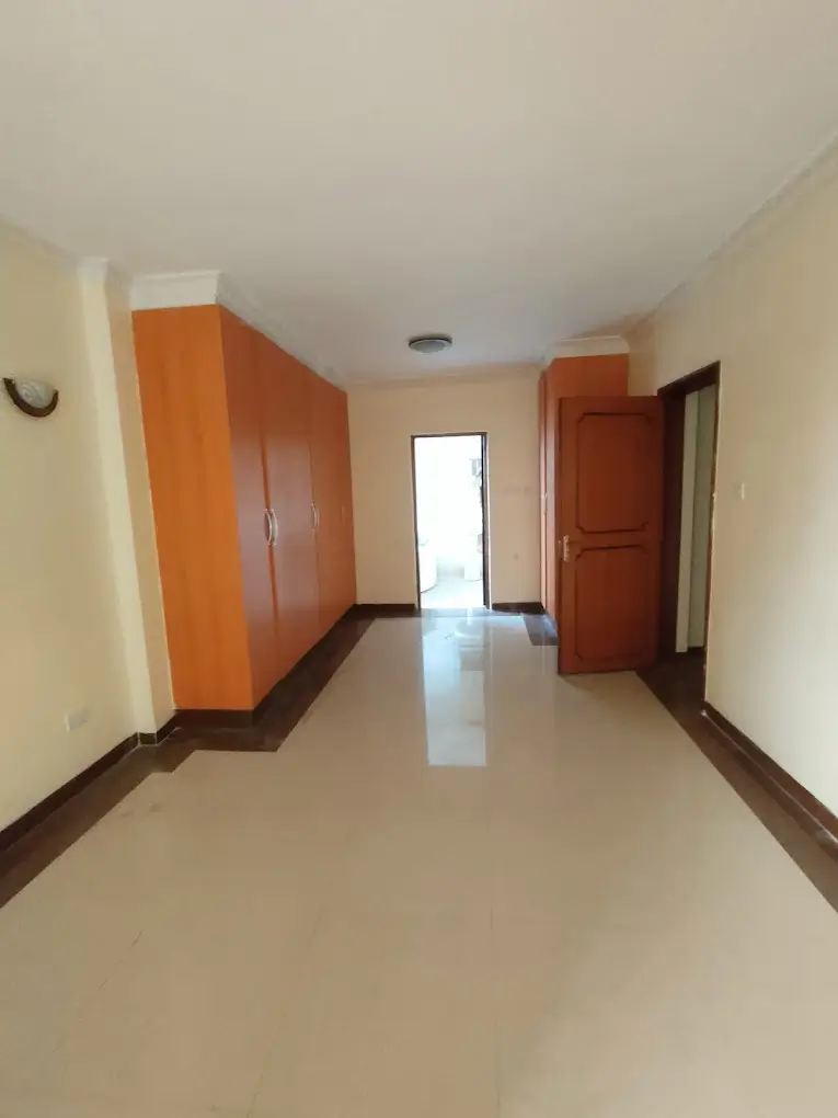 Bright corridor with wooden doors and polished floor