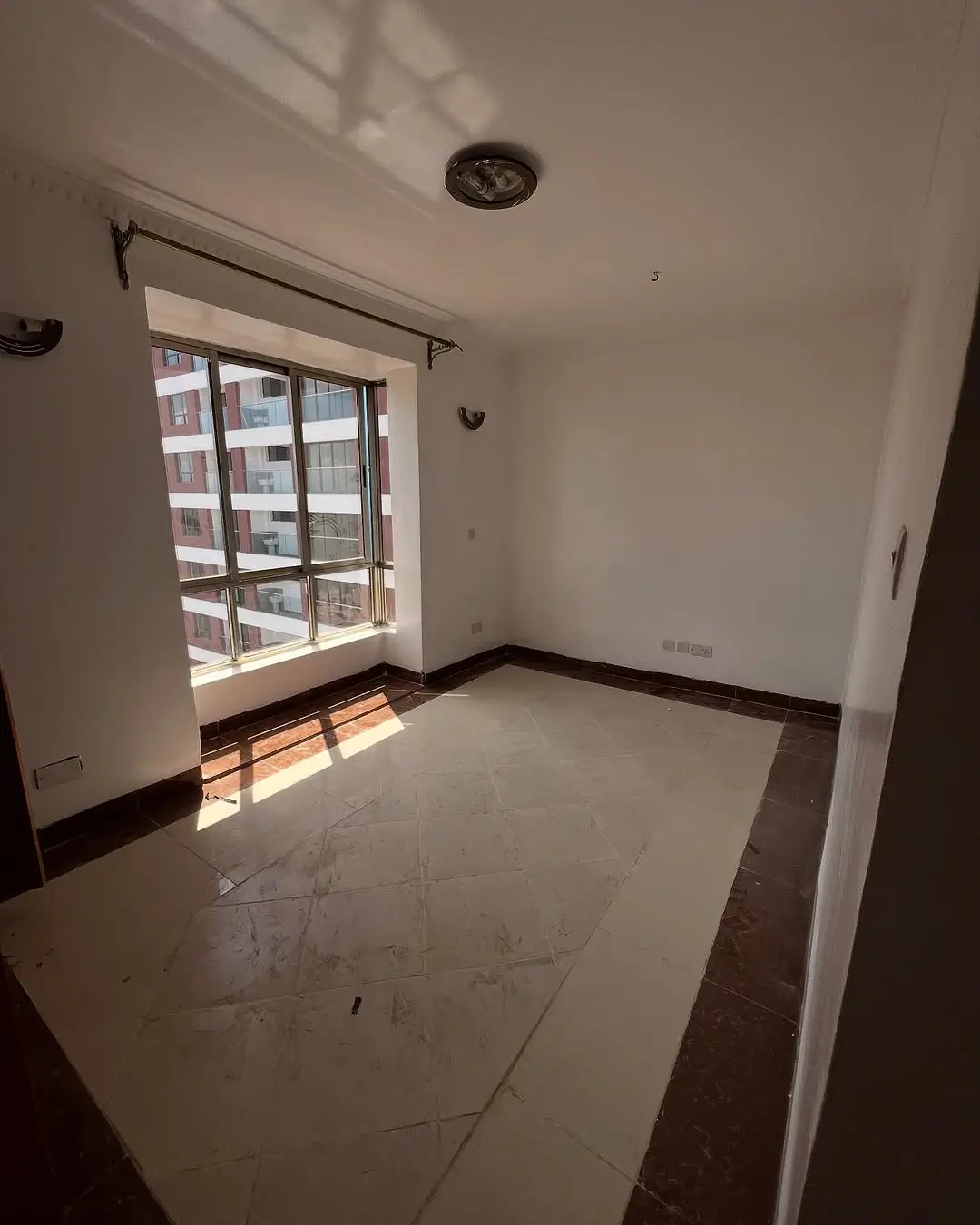 Bright living room with large window and polished concrete flooring