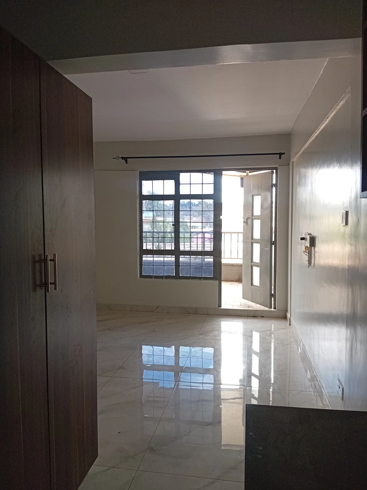 Bright corridor with polished floor and glass entrance doors