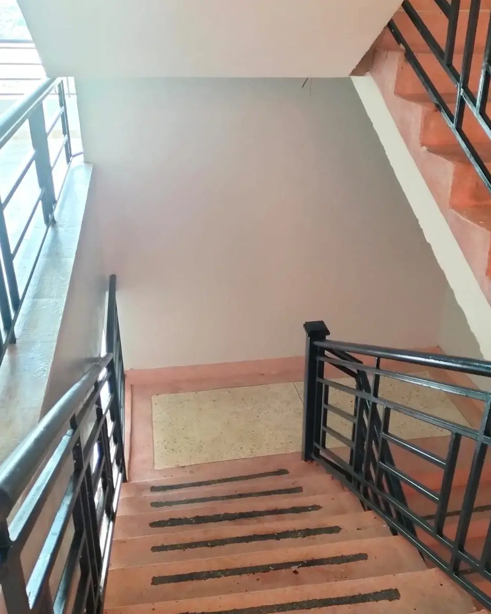 Interior stairwell with metal railings and landing