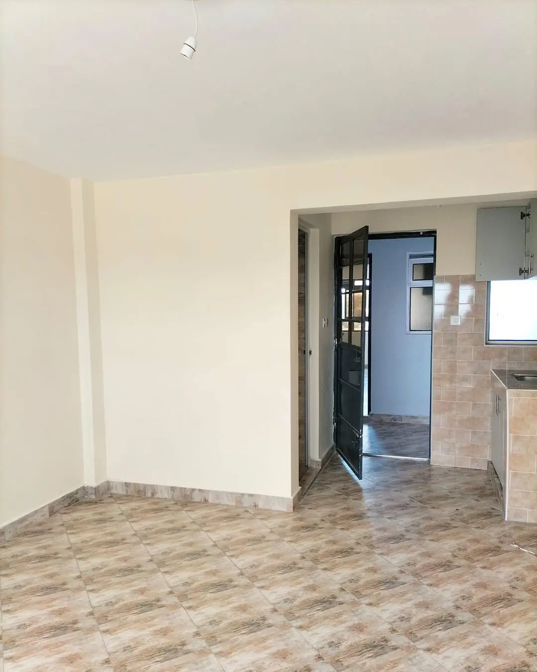 Open-plan living area with wood-look flooring and kitchen access