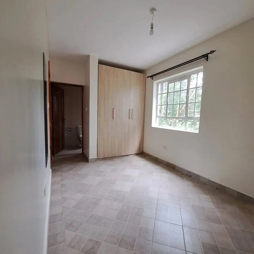 Spacious bedroom with built-in wardrobe and natural light