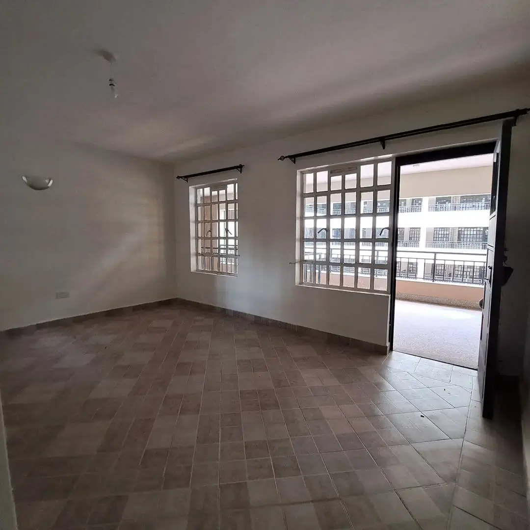 Spacious living room with tiled floor and sliding glass doors