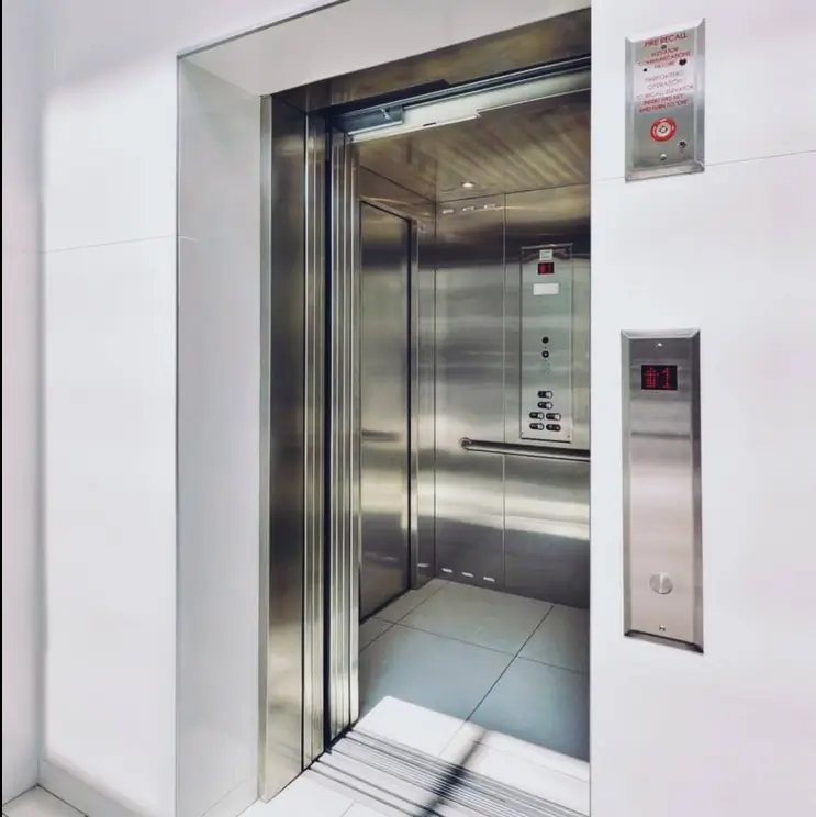 Modern stainless steel elevator with open doors in lobby